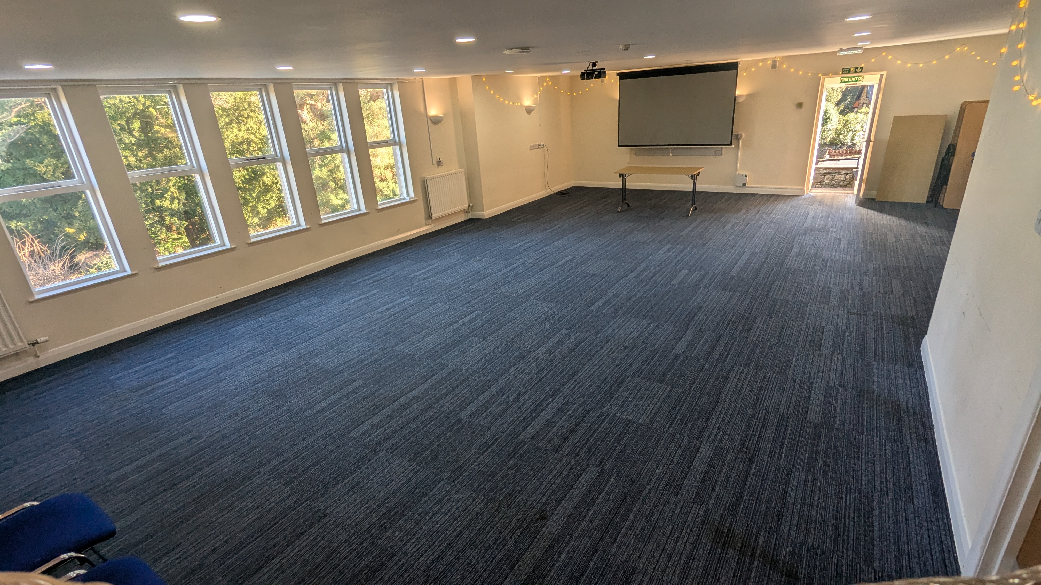 The bright conference room at Castlerigg with fell views and a projector screen